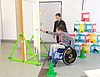 Rollstuhlfahrerin versucht Tür zu öffnen - Test an einem Parcours